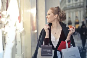 woman wearing black blazer holding shopping bags